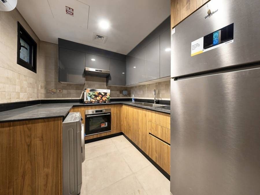Kitchen with oak-veneer cabinetry and granite worktops