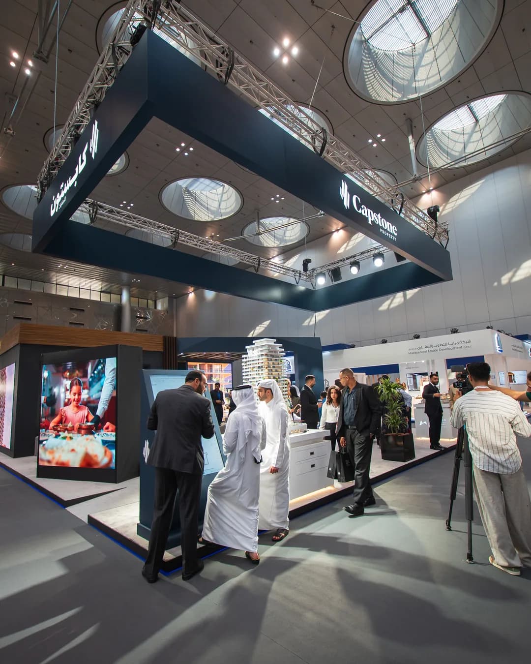 Visitors at Cityscape Qatar, the real estate exhibition in Qatar, meeting Capstone Property at the Doha Exhibition & Convention Center | زوار معرض سيتي سكيب قطر، معرض العقارات في قطر، يلتقون كابستون للعقارات في مركز الدوحة للمعارض والمؤتمرات